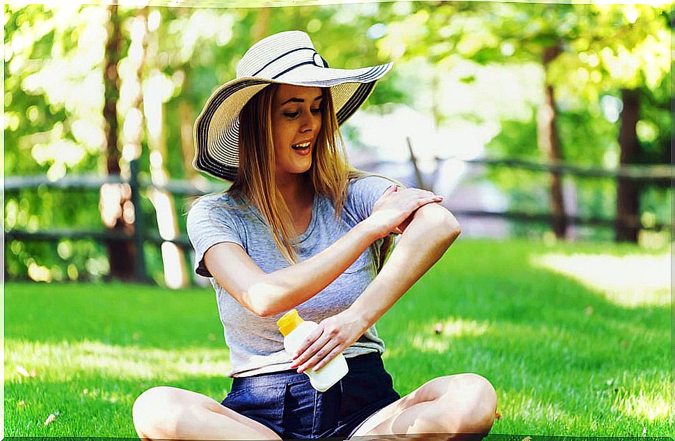 Woman applying sunscreen.