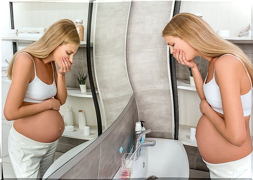 Pregnant woman feels nauseous in the bathroom.